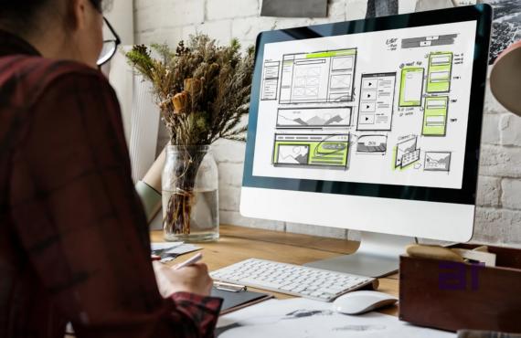 Person designing UI/UX website layout on computer screen at workspace, showcasing NexCorp Digital Services in web development, technology solutions, and digital business by Atul Raj.